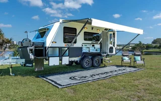 Sue & Garry M. with their van on the Elysium 19'6 · Big Lap